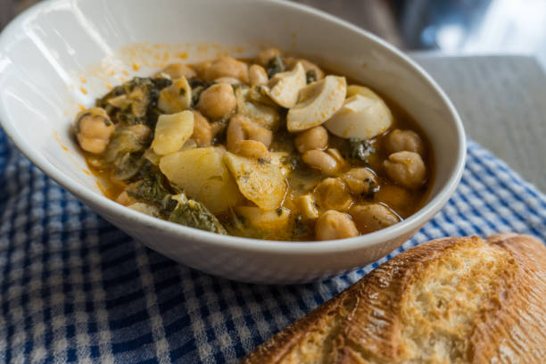 istock Chickpea stew with chard, boiled egg and potatoes on a blue checkered tablecloth 1265045553