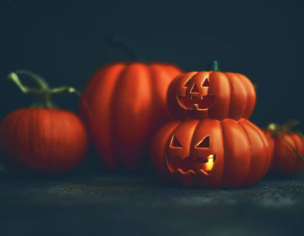 istock Halloween Background with Assorted Pumpkins and Glowing Jack O'Lantern 1265046246