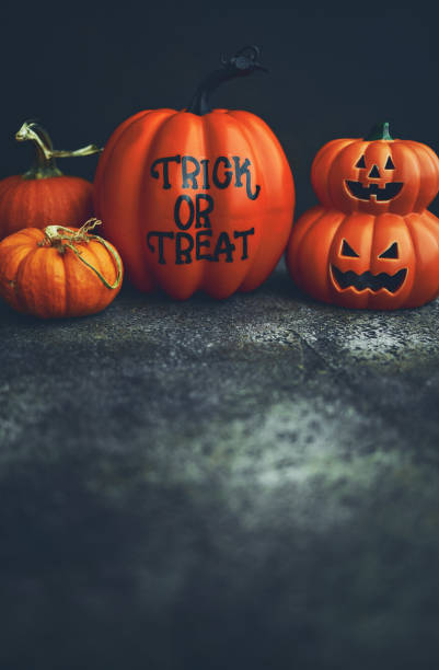 istock Halloween Background with Assorted Pumpkins and Trick or Treat Message 1265046277
