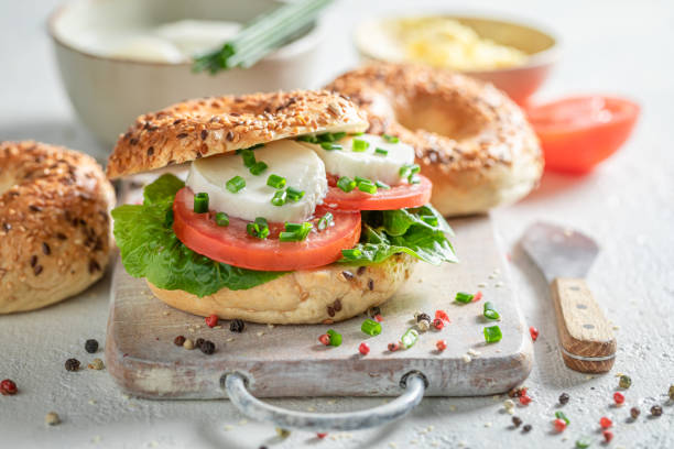istock Tasty bagel with mozzarella, tomatoes and lettuce 1265046405