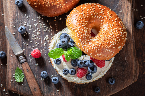 Delicious bagel with raspberries and blueberries for healthy breakfast