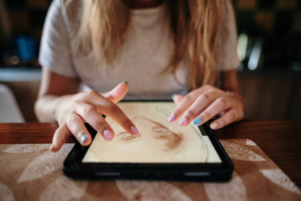 istock Young woman drawing on a digital tablet 1265046477