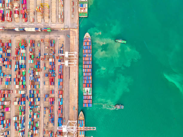 istock Container , container ship in export and import business and logistics. Shipping cargo to harbor by crane. Water transport International. Aerial view and top view 1265047361