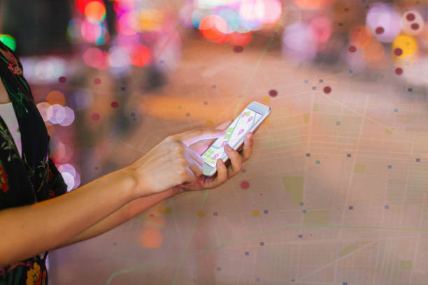 istock Multiple exposed image of map and hands holding mobile phone 1265051175