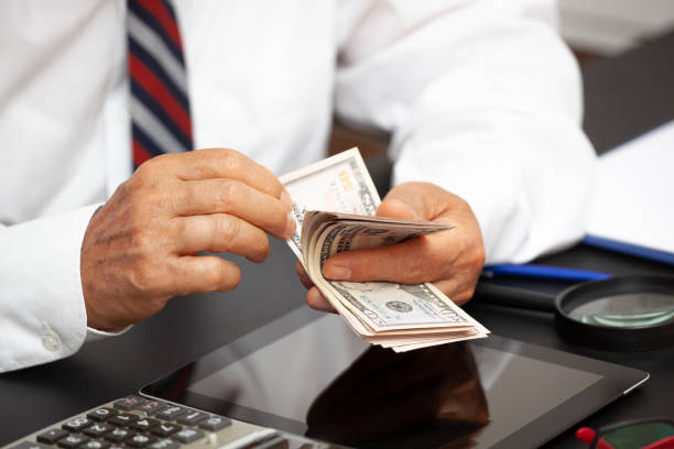 istock Senior man counting money. 1265051212