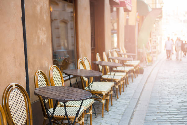 istock Empty tables in between dining hours. Old fashioned cafe terrace in a summer day 1265053763