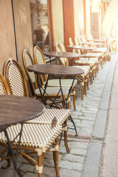 istock Empty tables in between dining hours. Old fashioned cafe terrace in a summer day 1265053784