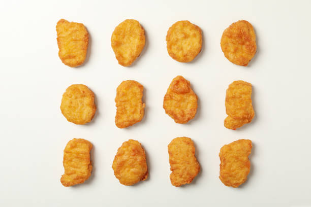 istock Flat lay with fried chicken nuggets on white background 1265060252