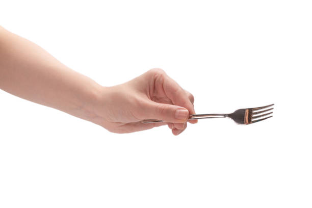 istock Fork in woman hand isolated on white. 1265060569