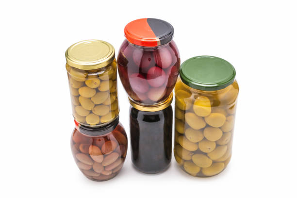 istock Olives in a bottle isolated on a white. 1265061083