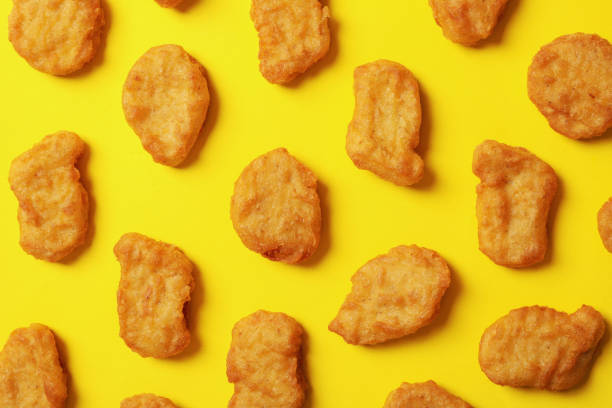 istock Flat lay with fried chicken nuggets on yellow background 1265061690