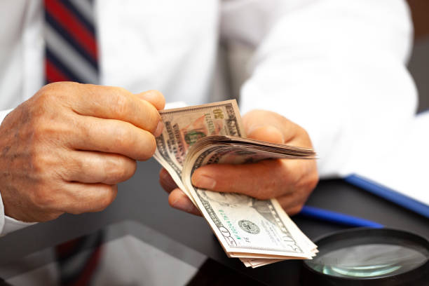 istock Senior man counting money. 1265062489