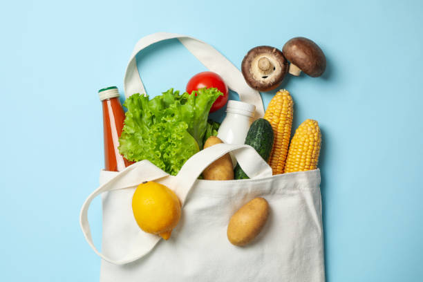 istock Cotton bag with different food on blue background, top view 1265062641