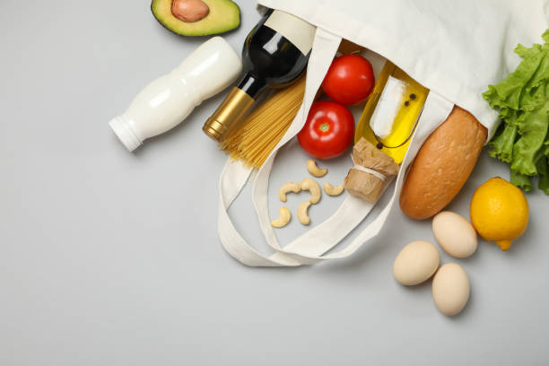 istock Cotton bag with different food on gray background, top view 1265063476