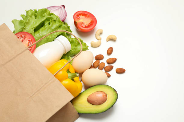 istock Paper bag with different food on white background 1265063585