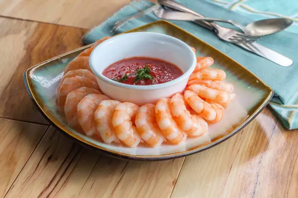 Delightful tail-on shrimp cocktail served with horseradish dipping sauce