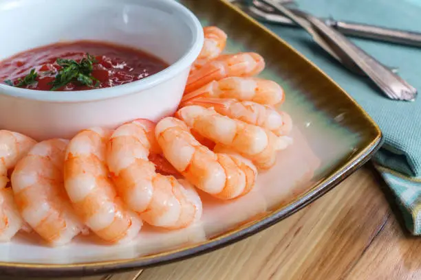 Delightful tail-on shrimp cocktail served with horseradish dipping sauce