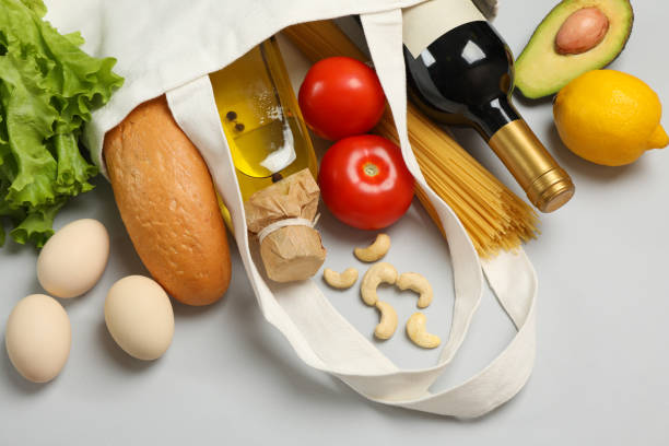 istock Cotton bag with different food on gray background, close up 1265065113