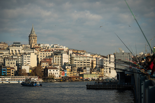 Galata Tower is in Istanbul City cloudy sky with fishing rods