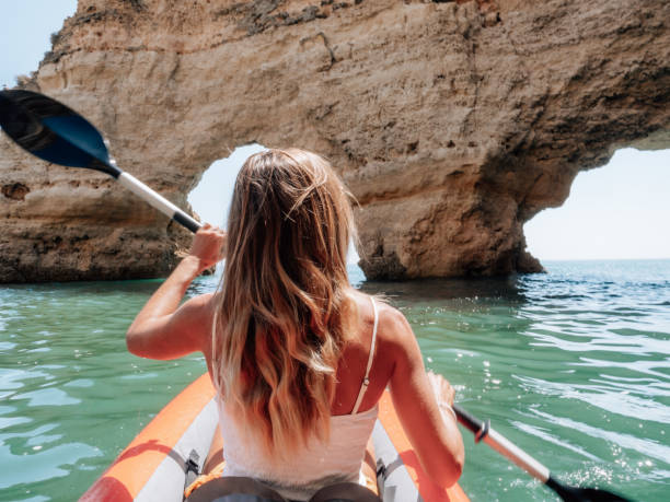 istock Rear view of woman on canoe 1265066574