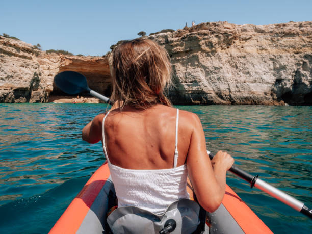 istock Rear view of woman on canoe 1265066580