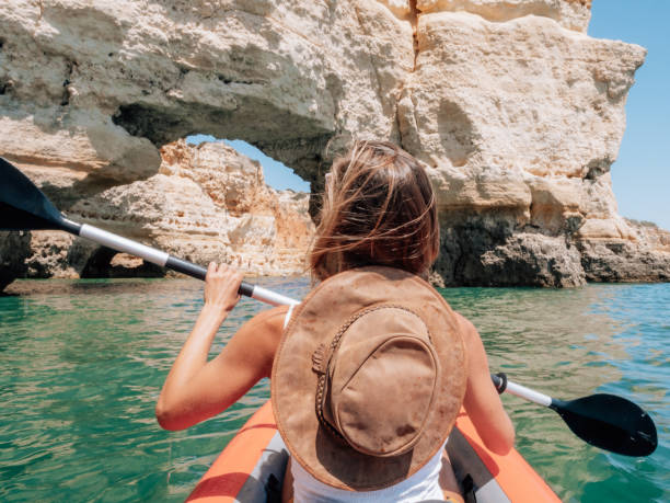 istock Rear view of woman on canoe 1265066596