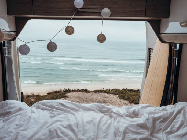 istock Back of a van overlooking the ocean, van life, bed view 1265066782