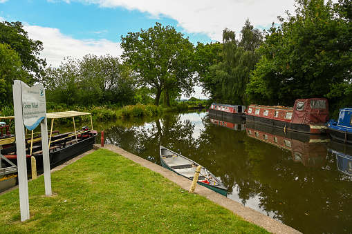 Goytre Wharf, Wales - July 2020: Information sign and narrow boats on the Brecon and Abergavenny canal.