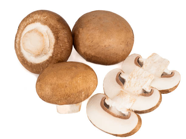 istock Champignons and their slices isolated on a white background 1265072092