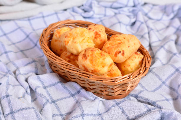 istock Brasilian cheese buns, coffee on a checkered napkin and wooden rustic table 1265073193