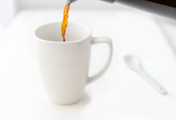 istock A fresh pot of coffee is being poured into a coffee mug. 1265074493