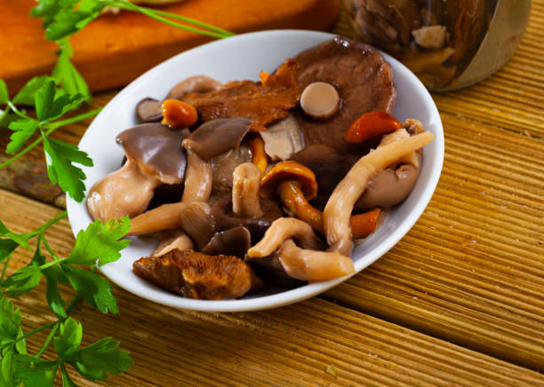 istock Assorted pickled mushrooms with onions and parsley 1265075979