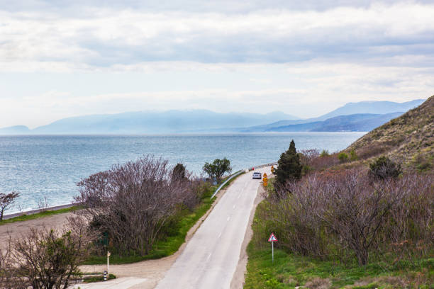 istock car is moving along the highway along the sea 1265079091