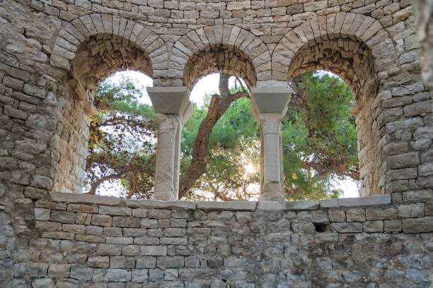 Arched windows of old stone church Antic arched windows of old ruined church on island Brac, village Povla, Dalmatia region, Croatia old catholic church on island brac croatia stock pictures, royalty-free photos & images