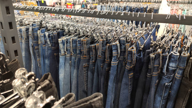istock Jeans hang in a store on hangers in a row 1265079824