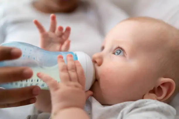 Baby boy drinking milk from milk bottle