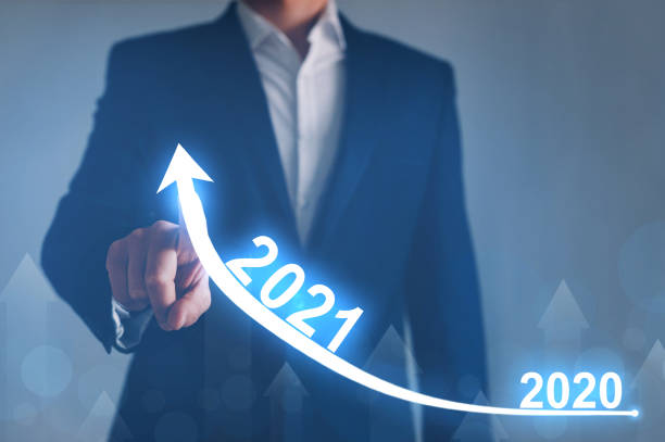 istock Businessman pointing arrow graph corporate future growth year 2020 to 2021. 1265080030