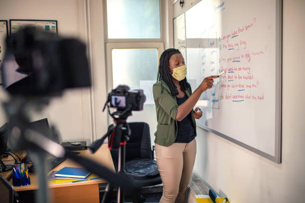 young afro american woman, female teacher standing near whiteboard - business seminar writing women imagens e fotografias de stock