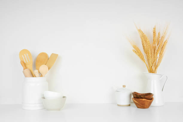 istock Kitchenware and utensils on a white shelf or counter against a white wall background with copy space 1265082197