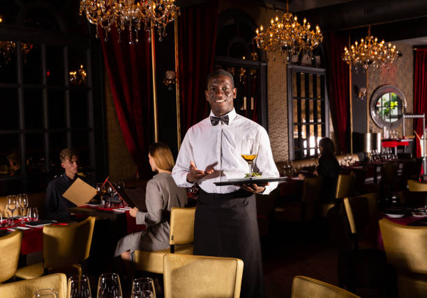 istock Waiter demonstrating tray of dish 1265083300