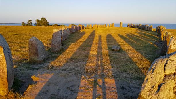 The Viking Monument Ale's Stones (Ales stenar), a megalithic monument in Skåne, Sweden. It is a stone ship, oval in outline, with the stones at each end markedly larger than the rest. ales stenar stock pictures, royalty-free photos & images
