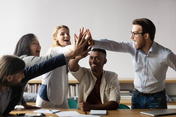 istock Overjoyed multiracial colleagues give high five engaged in teambuilding 1265084558