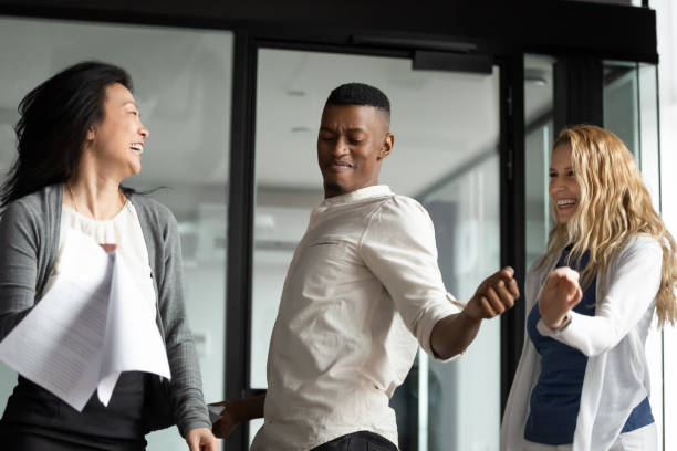 istock Excited diverse coworkers dance celebrate in office 1265084583