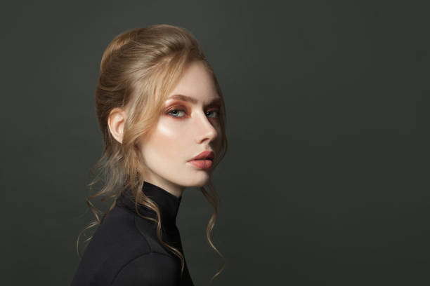 istock Pretty woman face on black background 1265084831