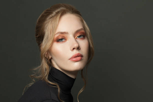 istock Attractive woman face on black background 1265084834