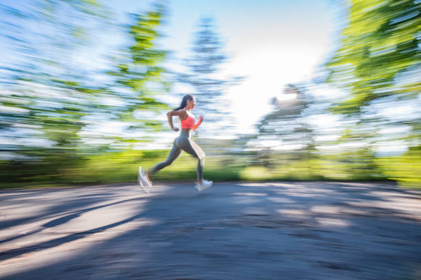 istock Fit woman running at park. 1265086787