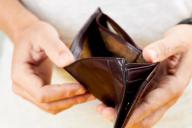 istock close up view caucasian person showing opened empty leather wallet. poverty concept. simple 1265087775