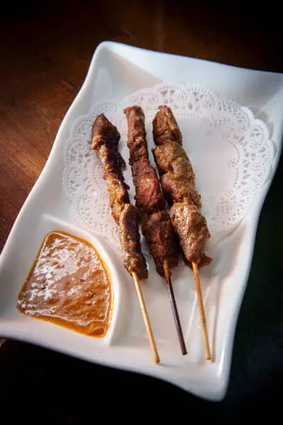 Thai beef satay skewers with spicy peanut sauce for dipping
