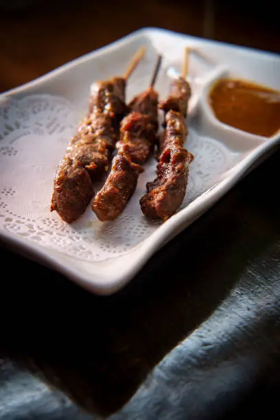 Thai beef satay skewers with spicy peanut sauce for dipping