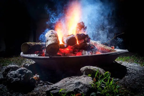 Summer camping fire pit with blue smoke